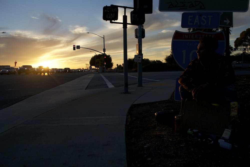 black and white street sign during sunset