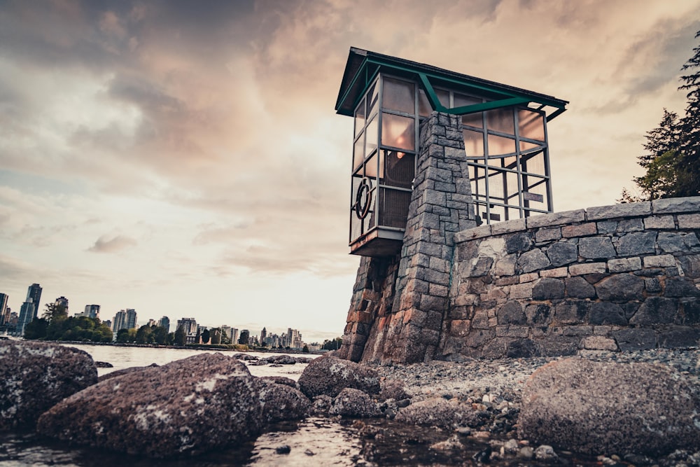 brown wooden house on gray sand during daytime