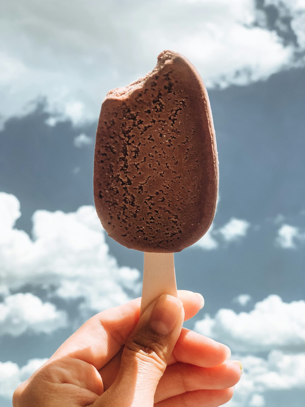 person holding brown ice cream