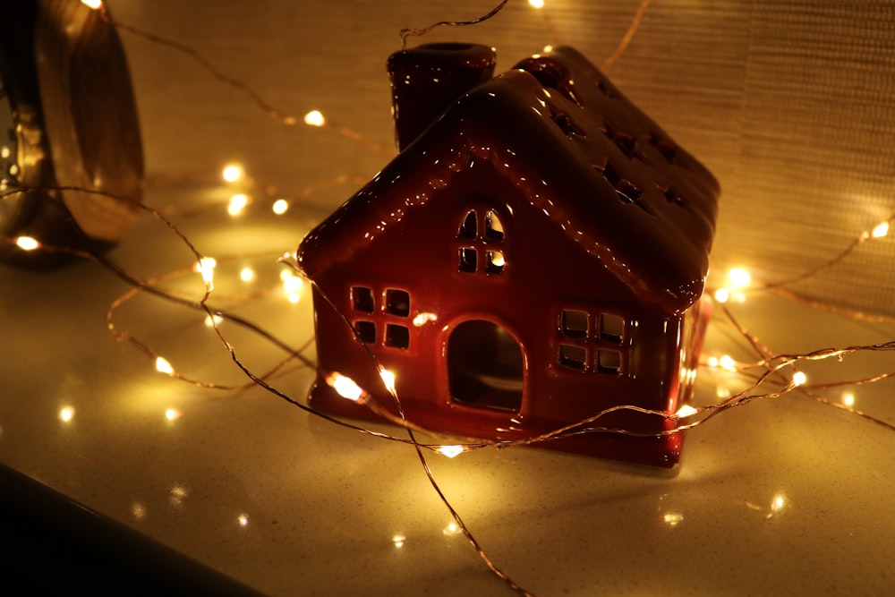 red wooden house with string lights