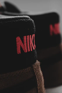 Close-up of a Nike shoe’s intricate stitching and luxurious materials under soft lighting.