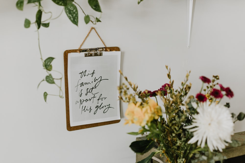 brown wooden frame with white and yellow flowers