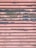 A metal surface with horizontal slats showing a distressed texture. The surface is painted in pink with worn-out blue sections, giving it a rustic look.