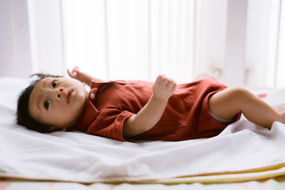 woman in brown shirt lying on bed