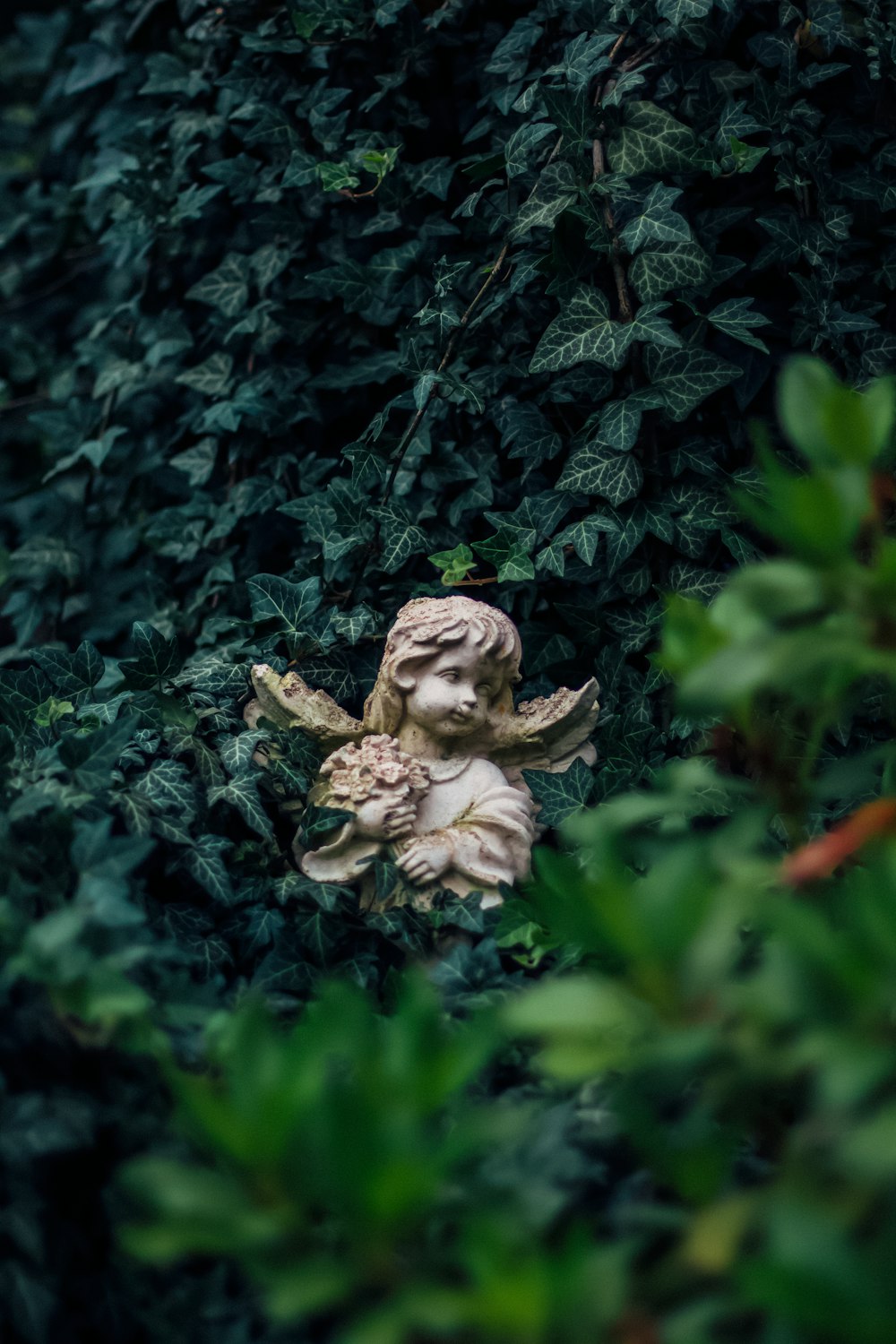 angel ceramic figurine on green plant