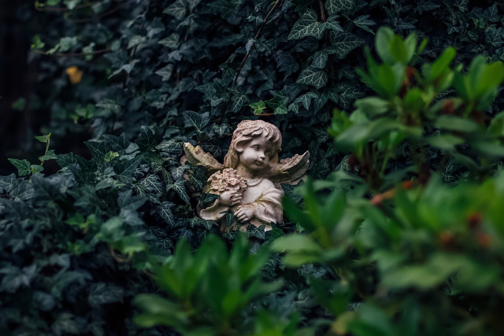 angel figurine on green plant
