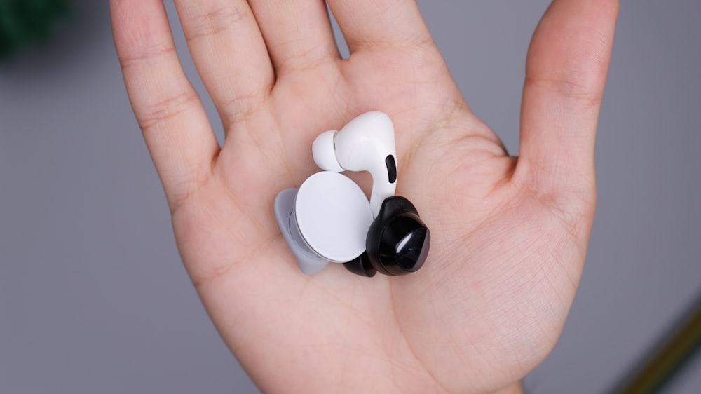 white and black ceramic mug on persons hand