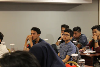 A thoughtful young leader engaged in a mentoring session in a bright, modern study space.