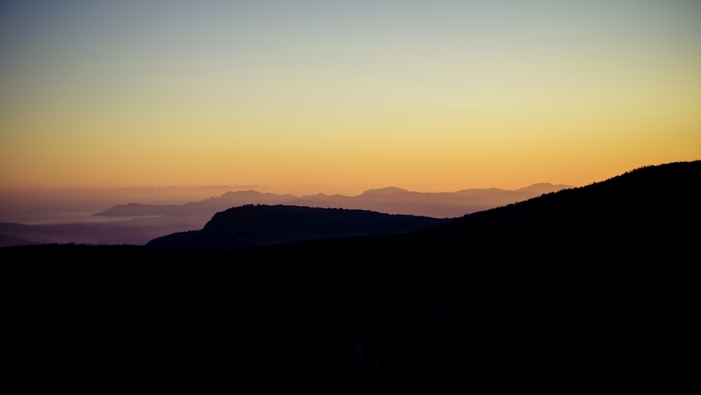 silhouette of mountains during sunset