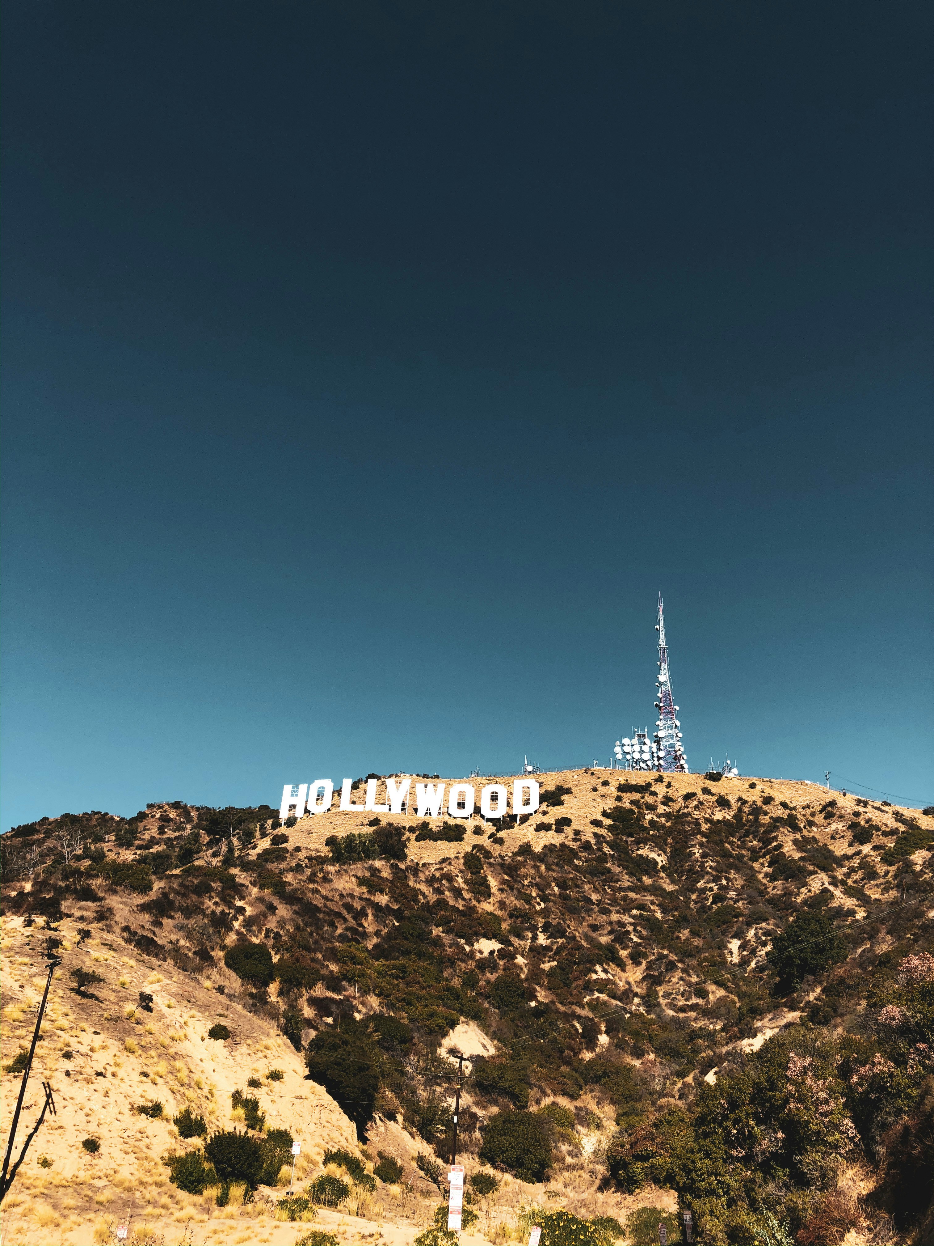 white concrete building on brown rocky mountain under blue sky during daytime