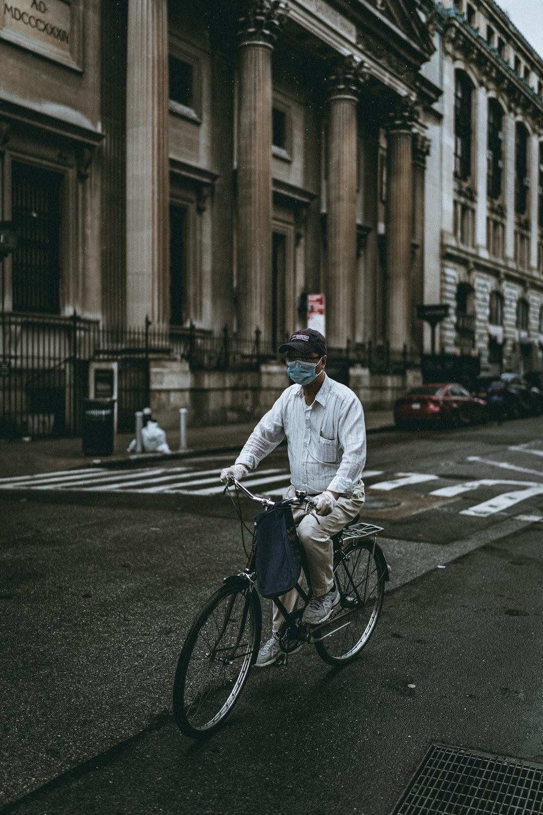 man in white dress shirt riding bicycle on road during daytime
