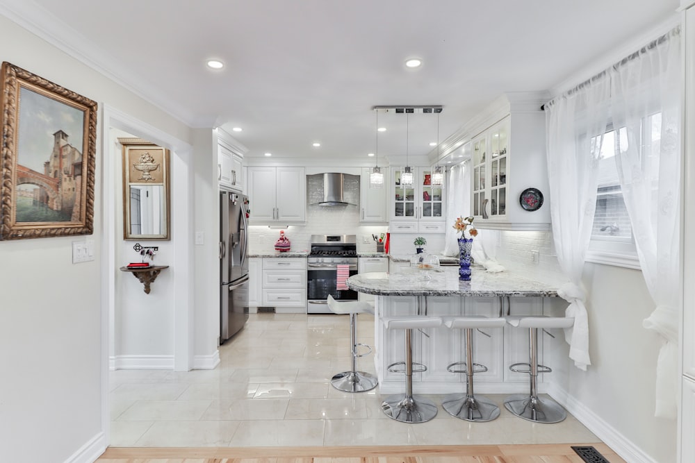 white wooden kitchen cabinet near white wooden door