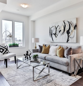 gray sofa near glass table