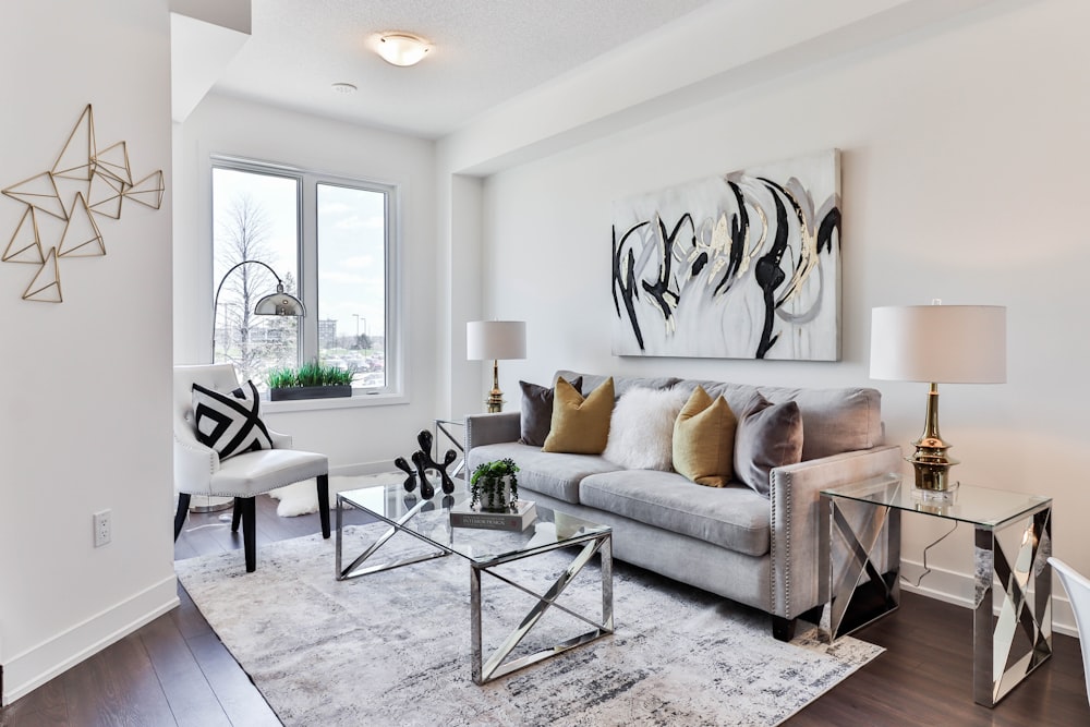 gray sofa near glass table