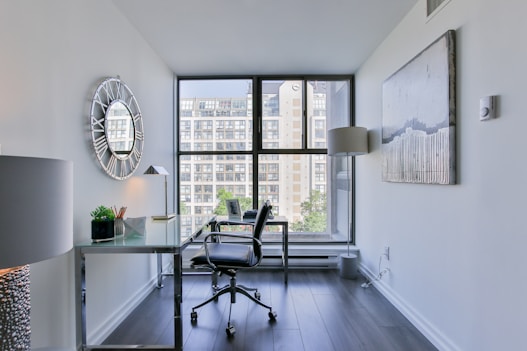 black office rolling chair beside white wooden desk