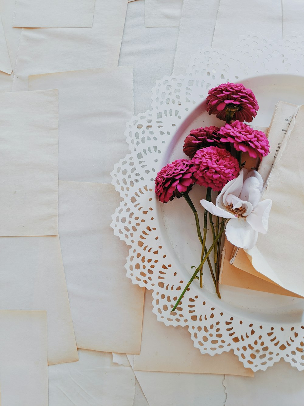 pink and white flower bouquet on white table cloth