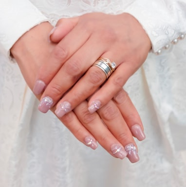 woman wearing silver ring and white floral lace dress