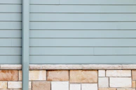 Before and after side-by-side comparison of a home’s exterior with old siding replaced by James Hardie panels.