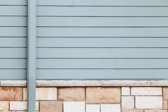 Close-up of new gray fiber cement siding on a Dayton home, highlighting clean lines and texture.