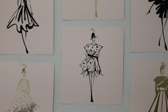Close-up of colorful digital fashion sketches displayed on a laptop screen.