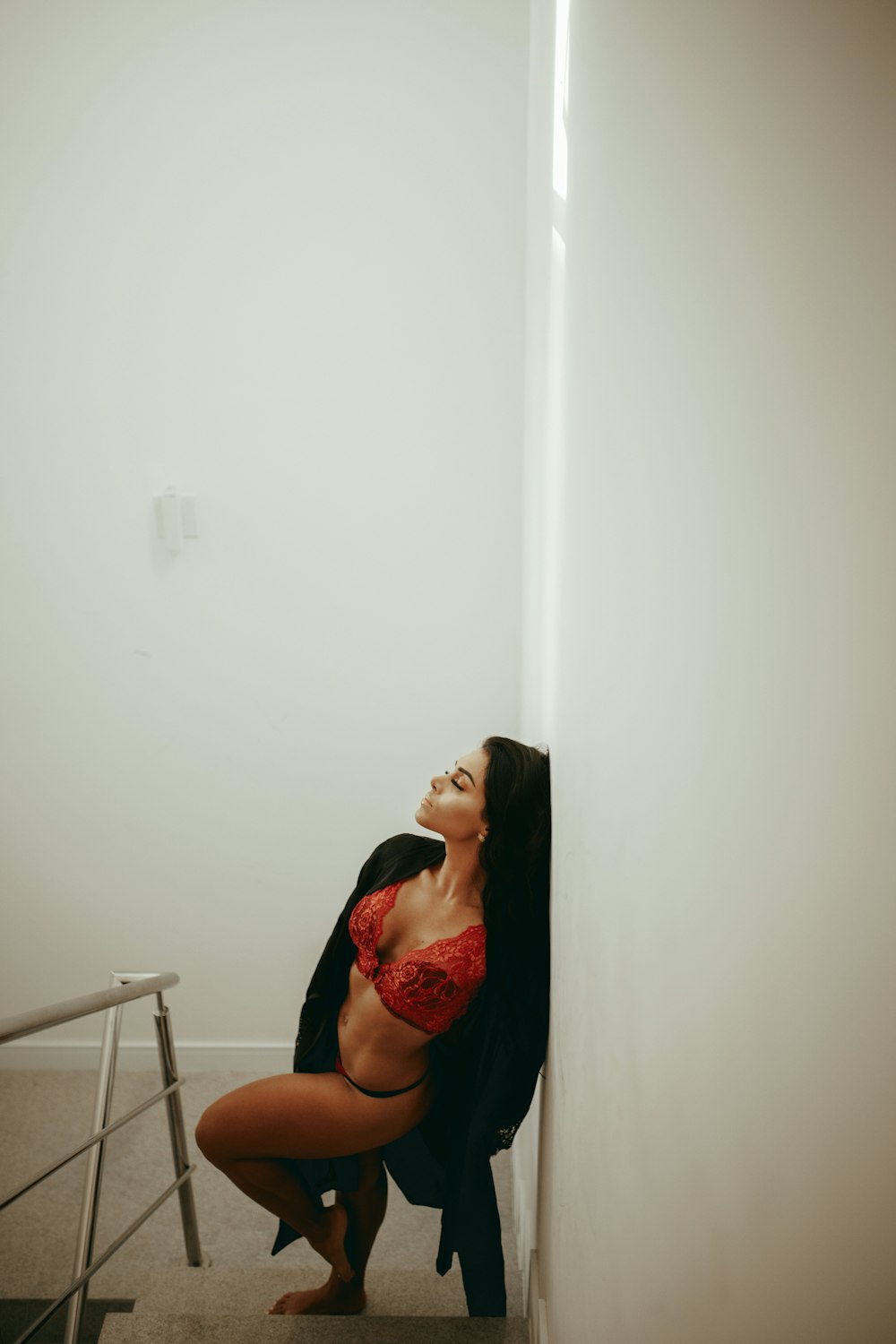 woman in red floral dress sitting on chair