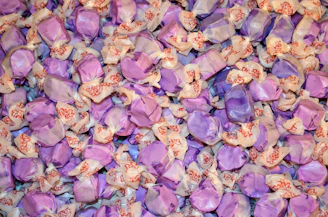 A collection of customized party supplies featuring purple-themed designs and names.