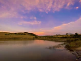 A delicate landscape with pastel skies and a quiet, reflective lake.