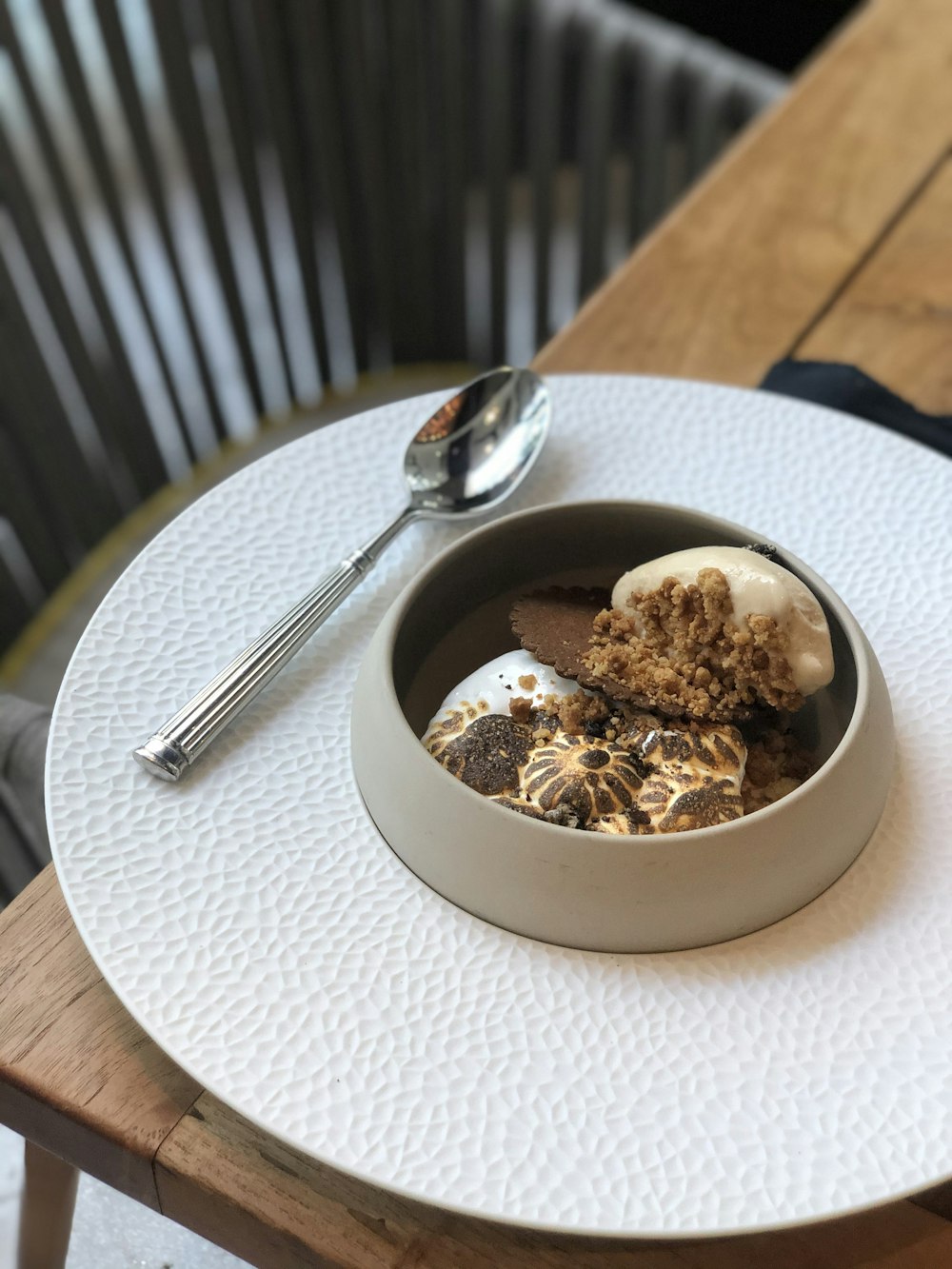 white ceramic bowl with brown food on white table cloth