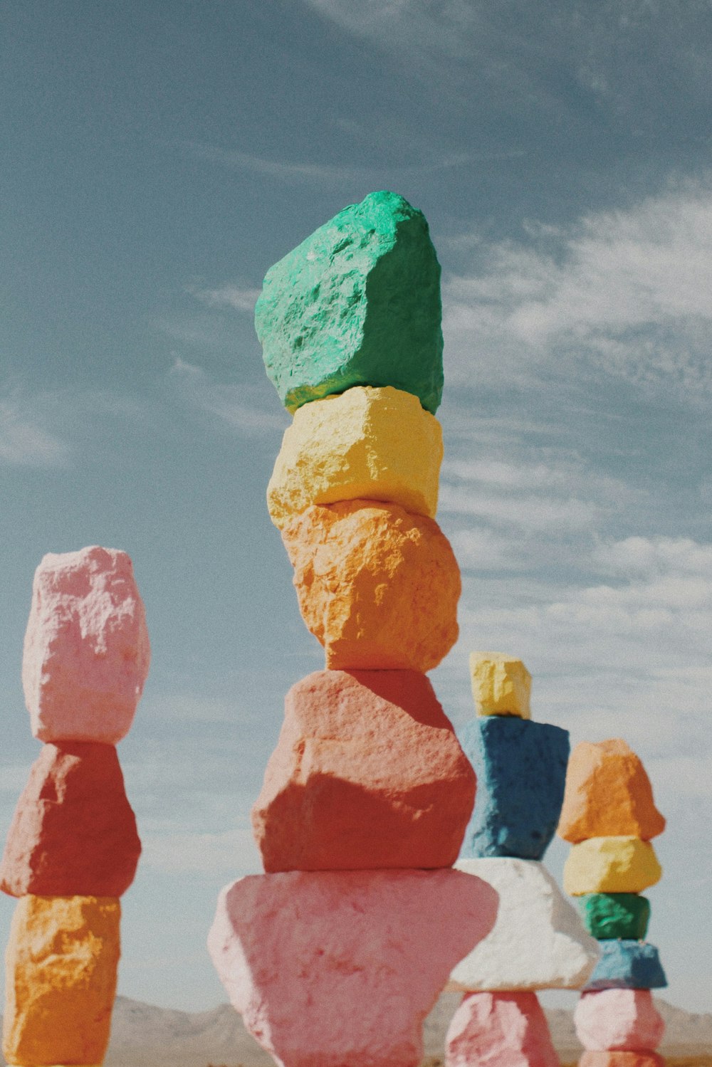 orange and green stone under blue sky