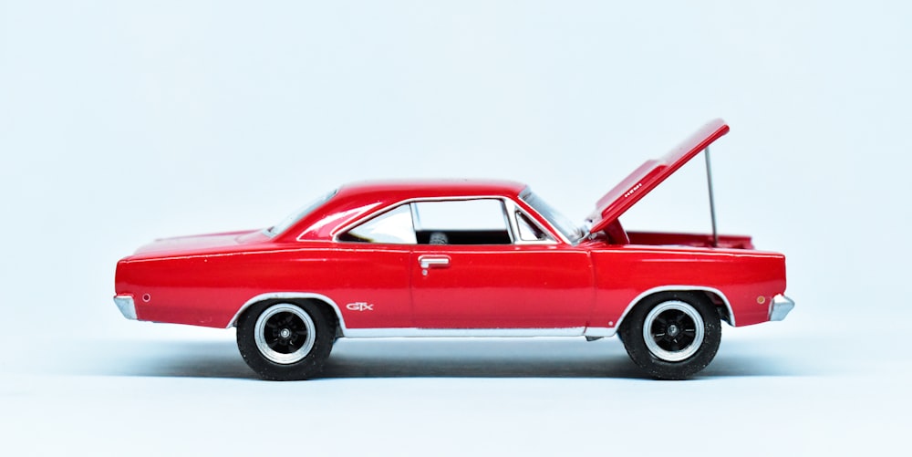 red coupe on white background
