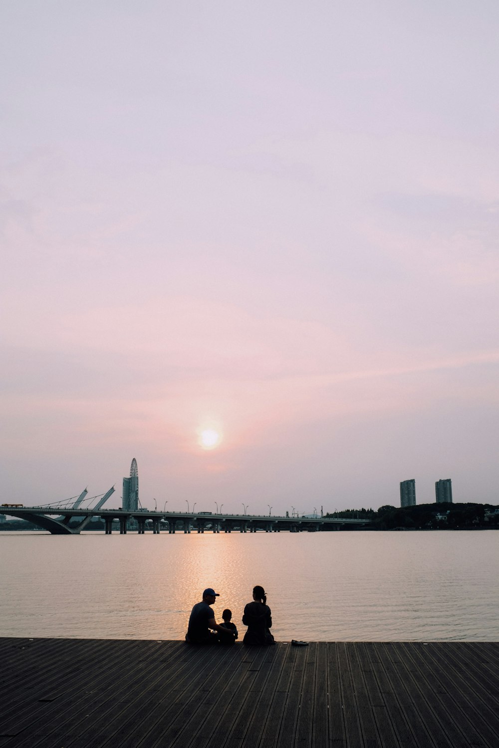 silhouette of people on dock during daytime