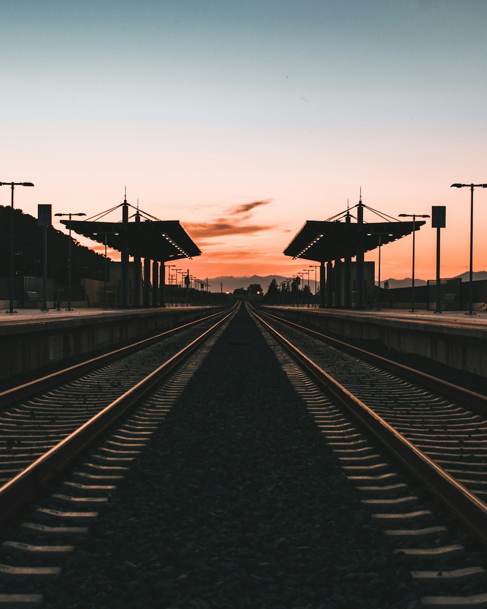 train rail near houses during daytime