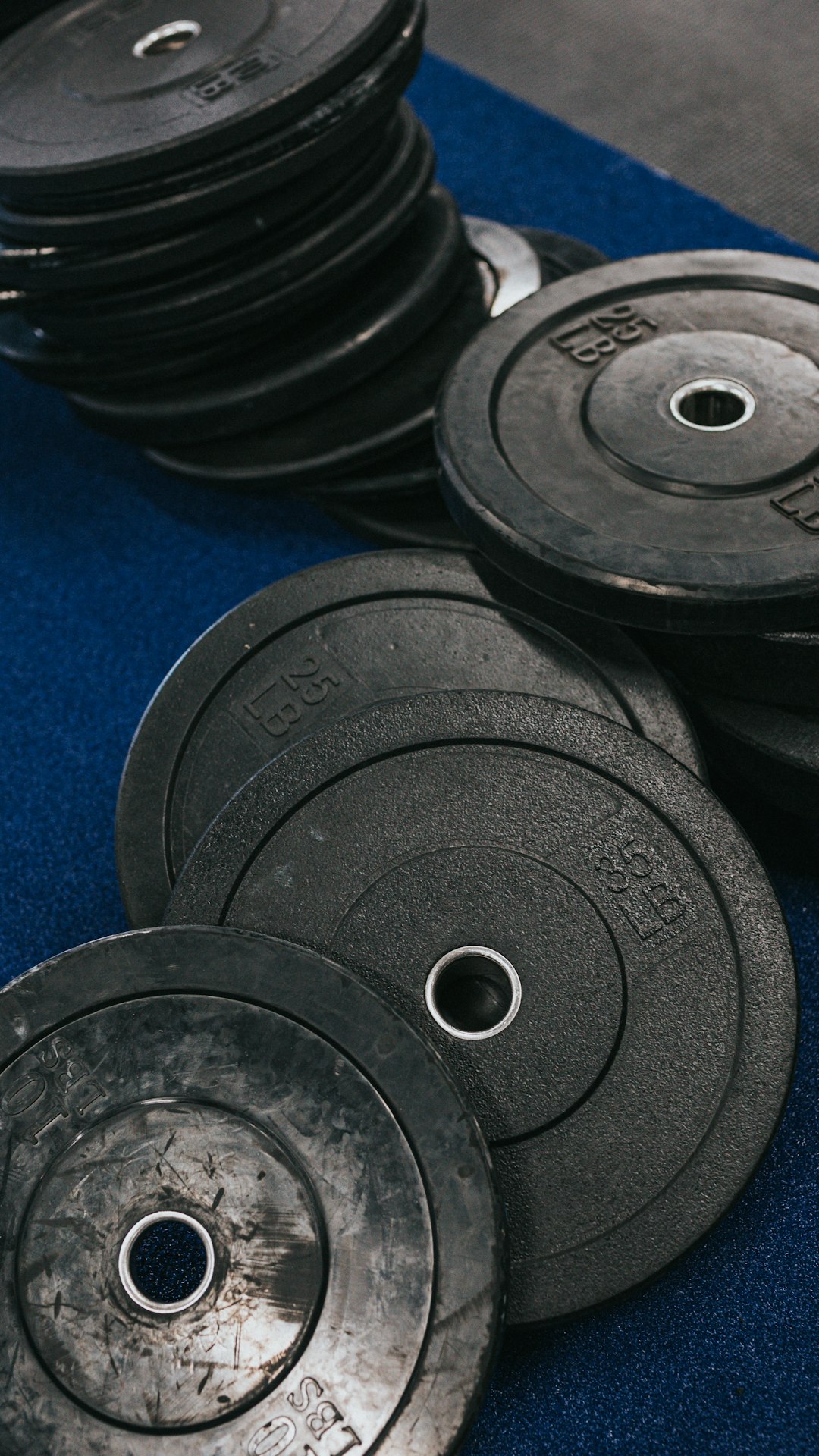 black weight plates on blue textile