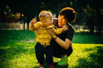 boy in yellow and black plaid button up shirt carrying girl in yellow and black plaid
