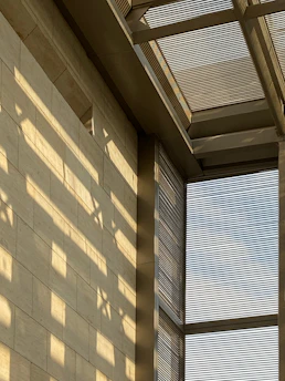 Sunlight filtering through modern architectural details of a Pune building.