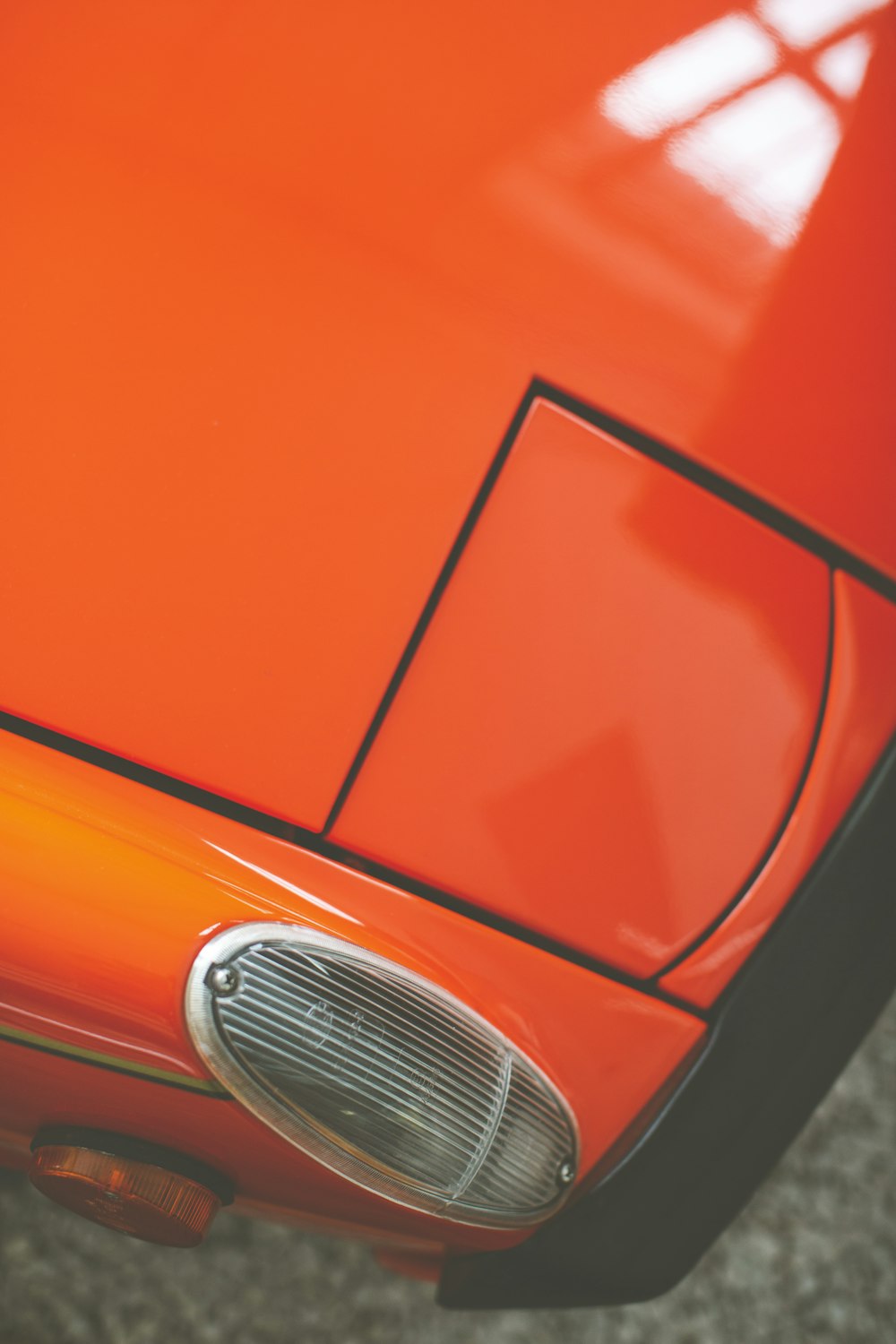 orange car with white license plate