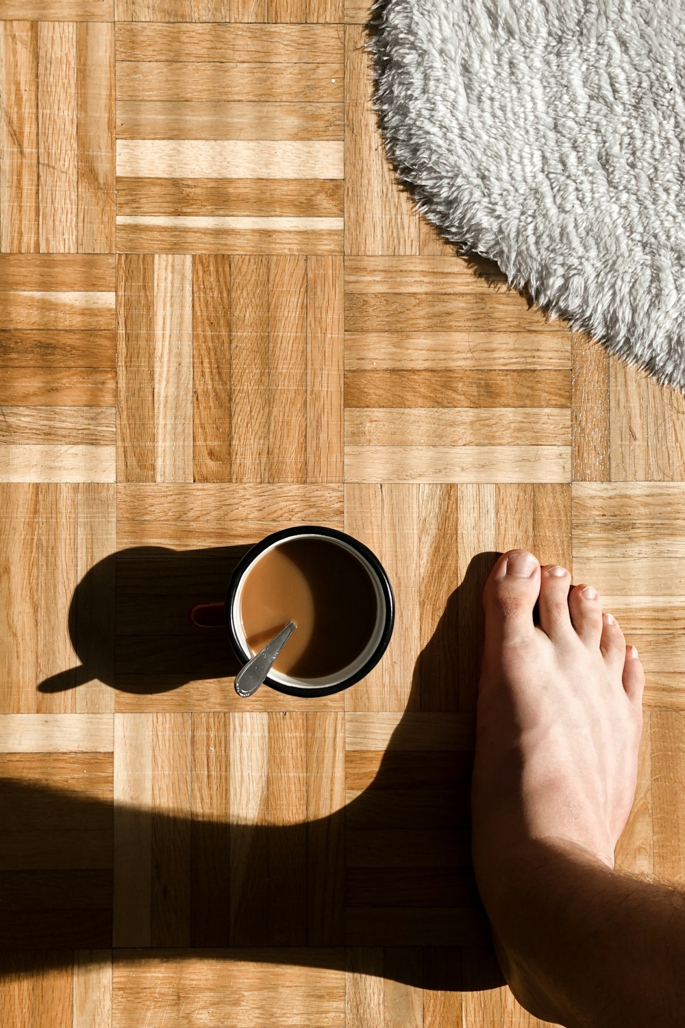 person holding black ceramic mug with black liquid