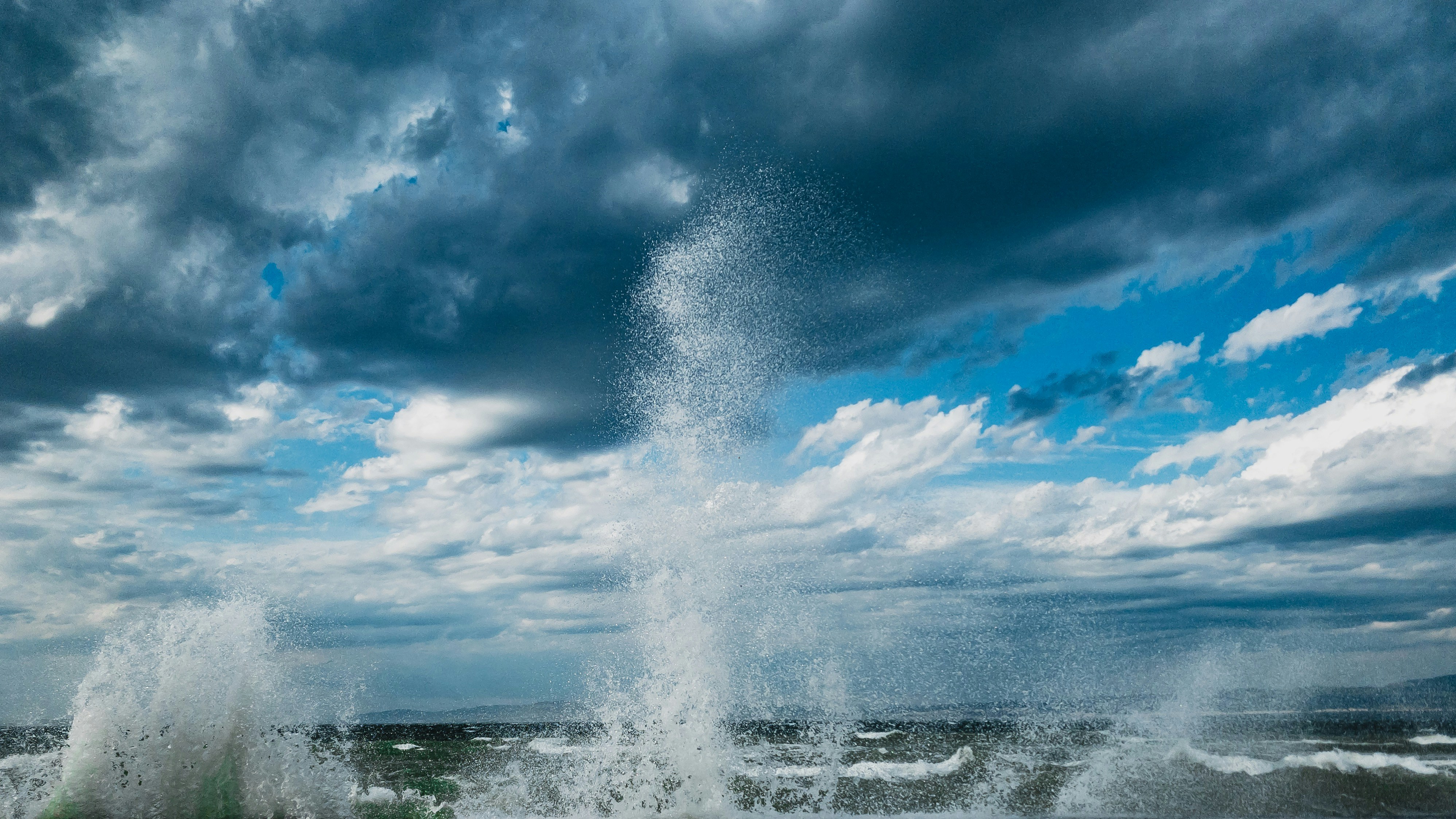 ocean waves under blue sky and white clouds during daytime
