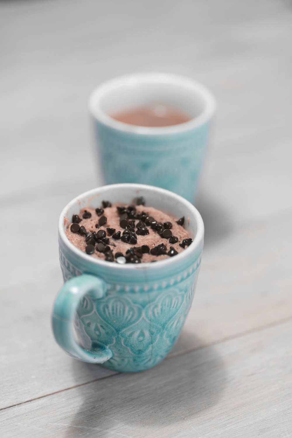 blue ceramic mug with brown and black liquid