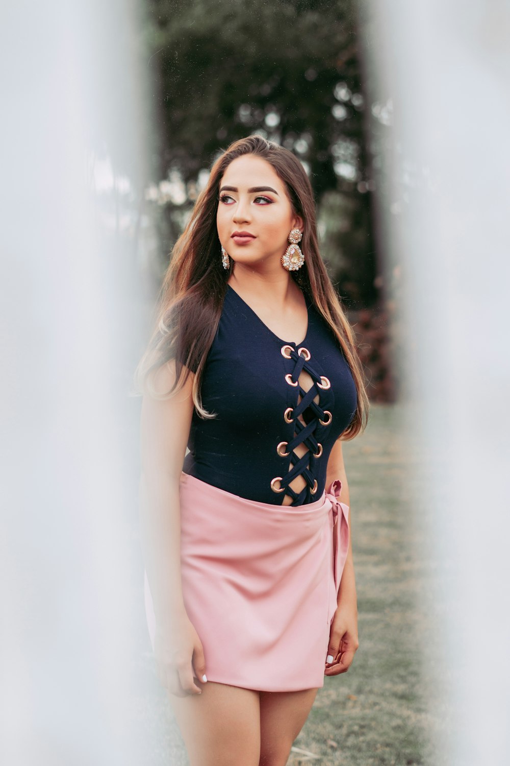 woman in black tank top and pink skirt