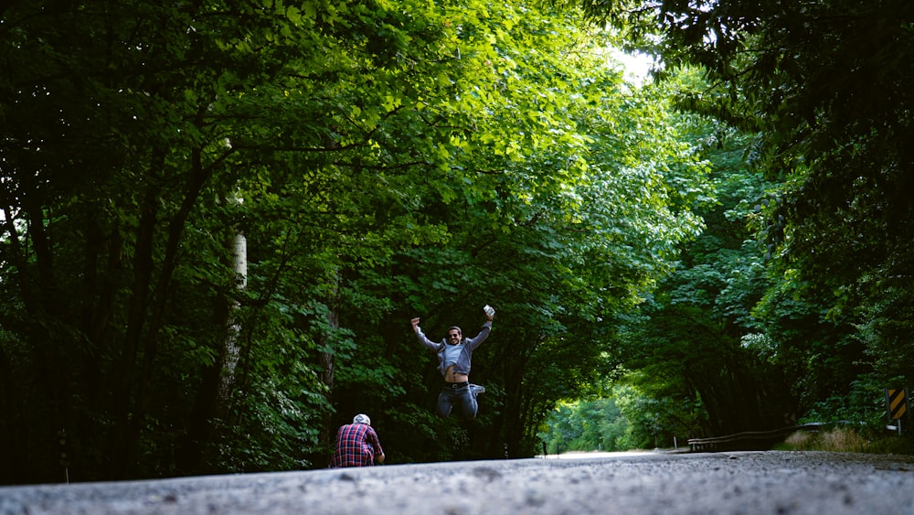 2 girls in pink and white dress running on road during daytime