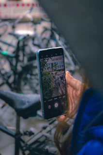 Close-up of hands booking an e-bike rental on a smartphone screen.