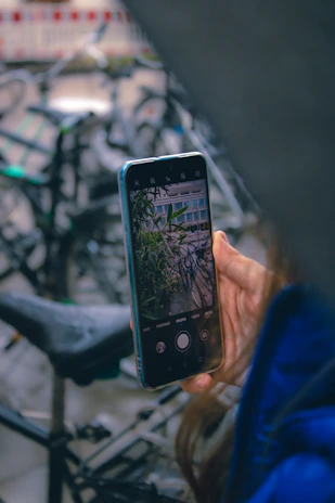 Close-up of hands booking an e-bike rental on a smartphone screen.