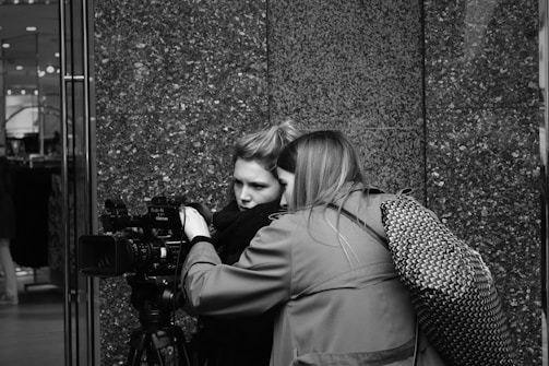 A director and cinematographer reviewing footage on a monitor during a commercial shoot.