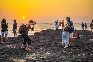 people walking on brown sand during sunset