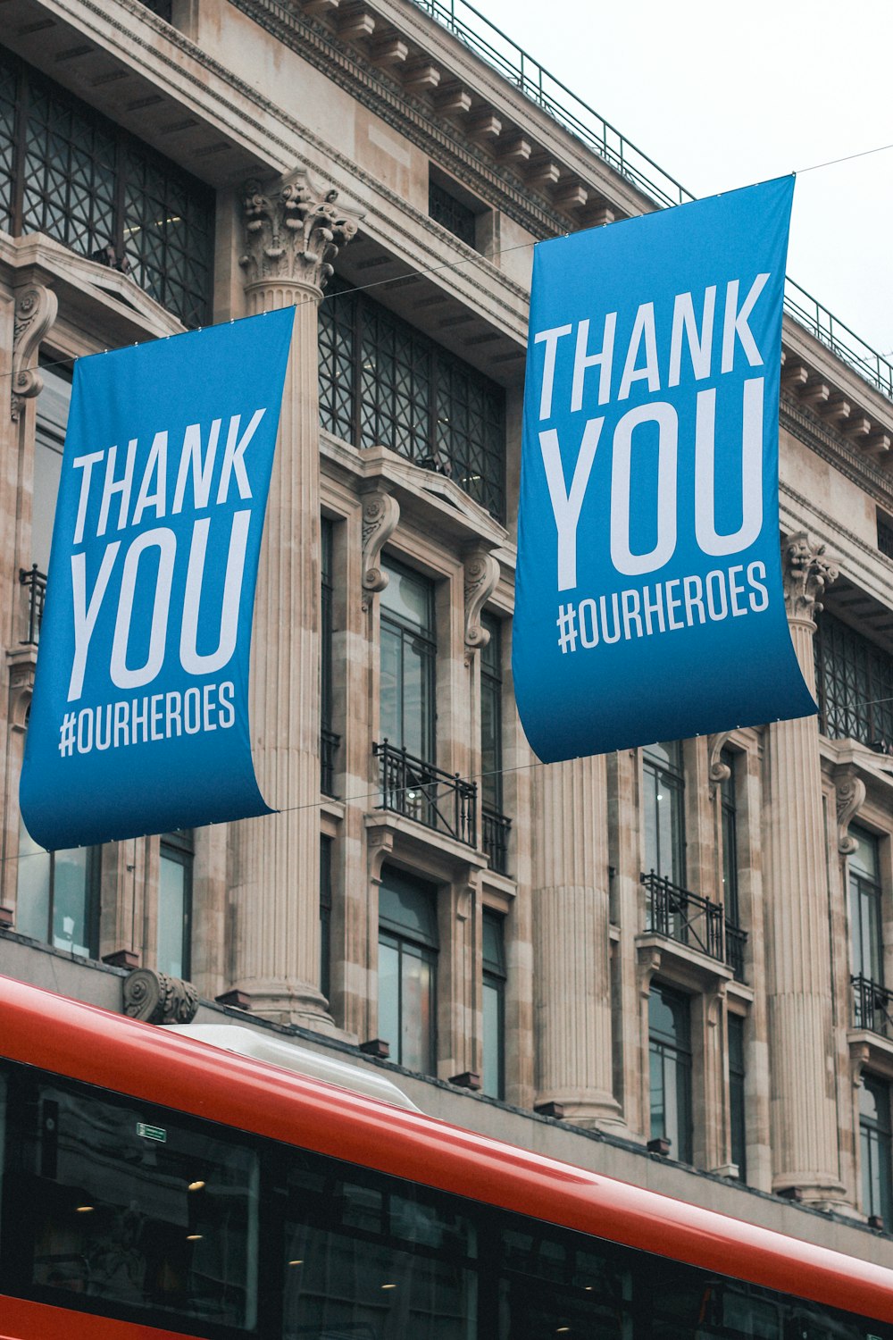 Street banners reading thank you hanging on a building