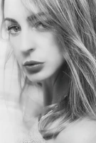 A tasteful black and white portrait of a woman with a mysterious smile.