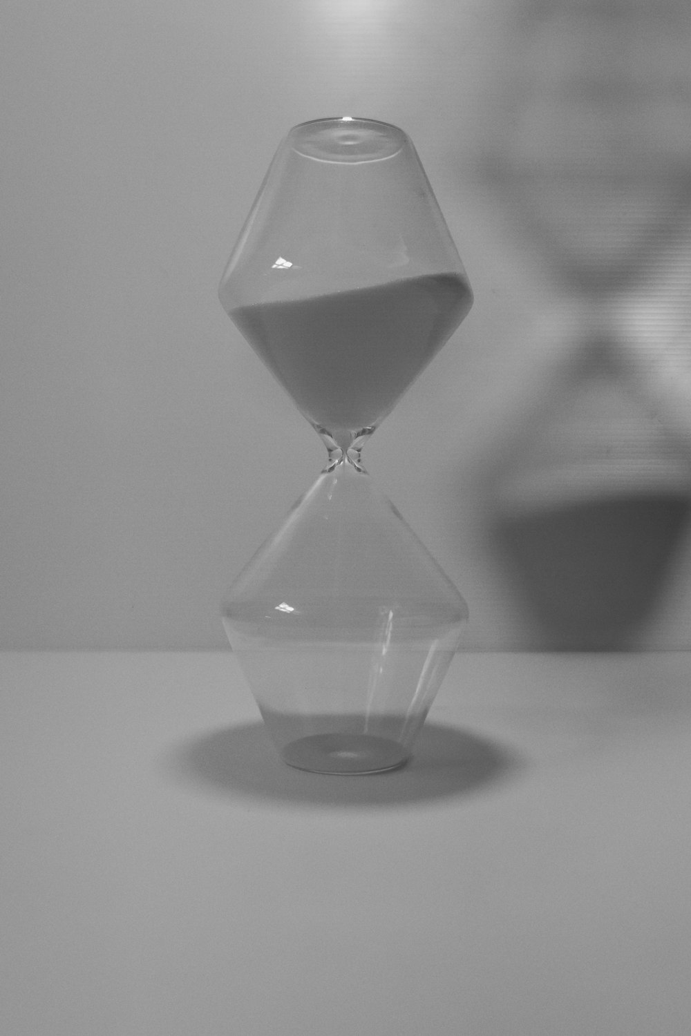 clear hour glass on white table