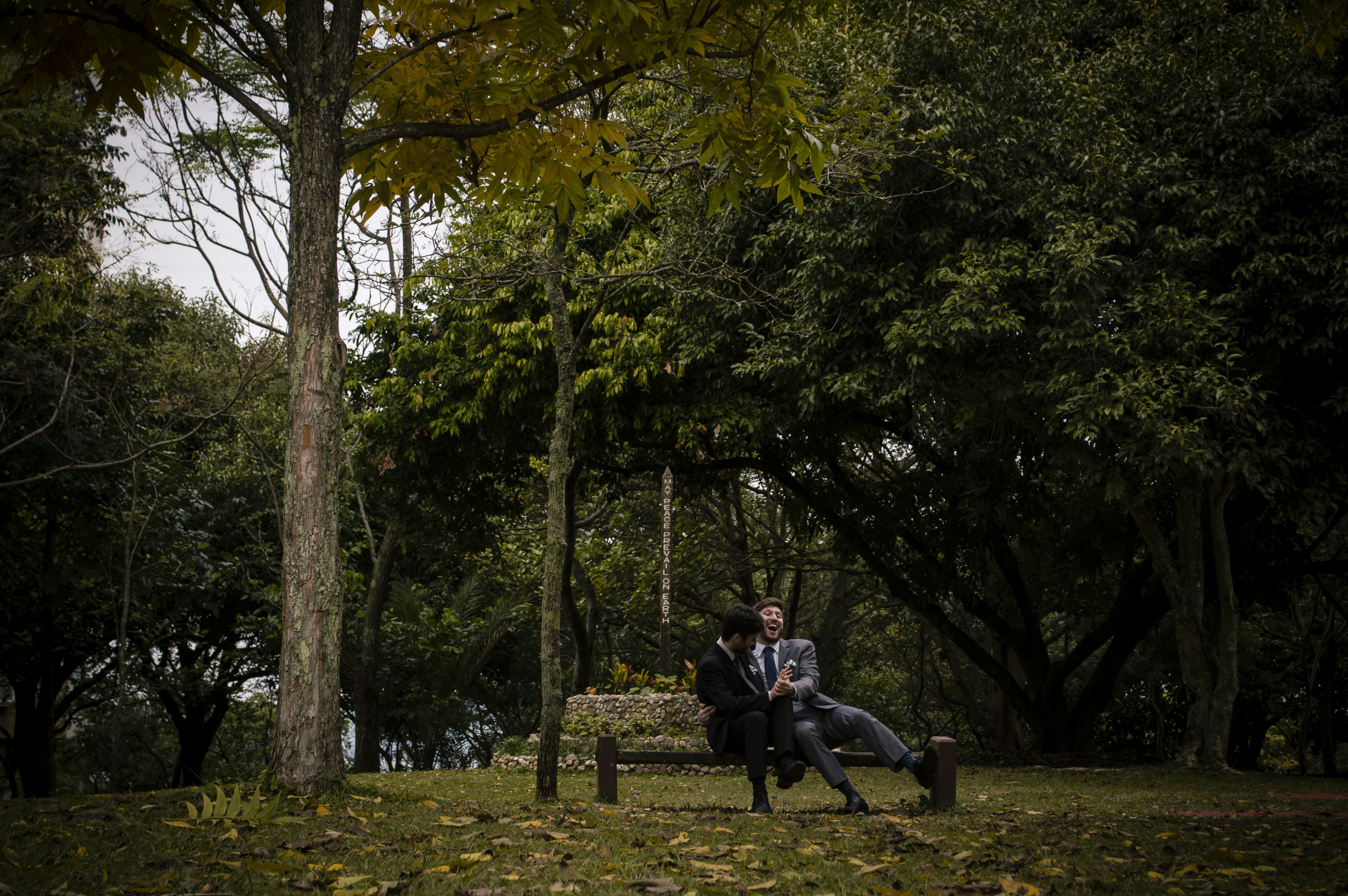 Happy couple playing on a bench.