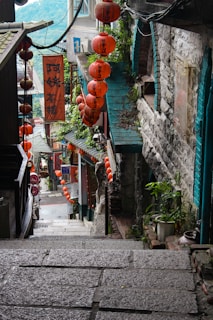 red and brown hanging decors on green concrete wall during daytime